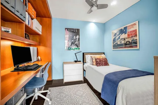 a bedroom with a bed and a large window