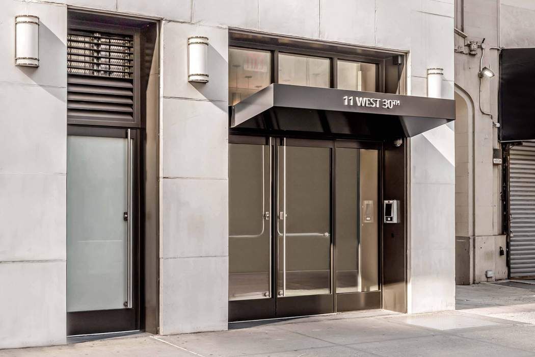 11 West 30th Street, Unit 8F Manhattan, NY 10001 - Photo 17 of 20 a view of a hallway with wooden floor and entryway