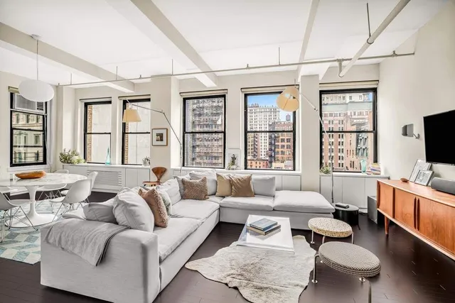 a view of a dining room with furniture a rug and wooden floor