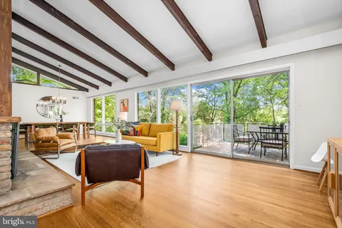 a living room with furniture and a floor to ceiling window