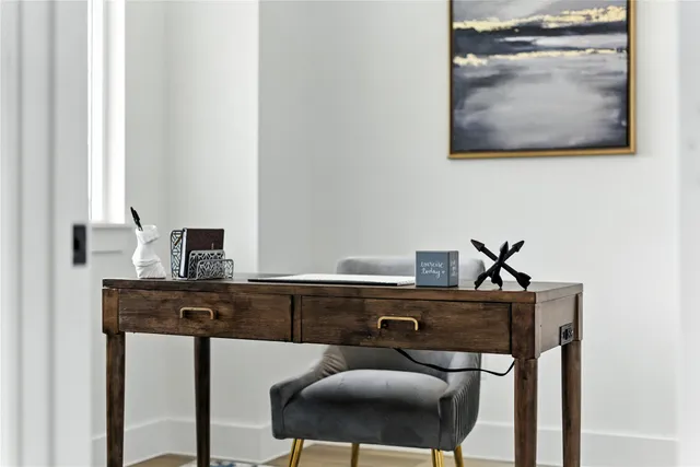 a view of a workspace room with furniture and wooden floor