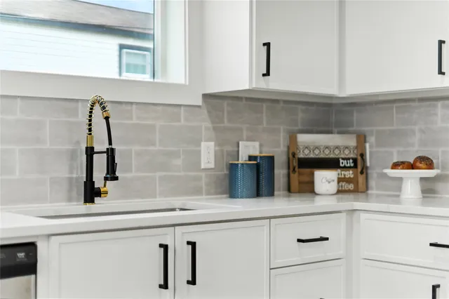 a kitchen with a sink and cabinets