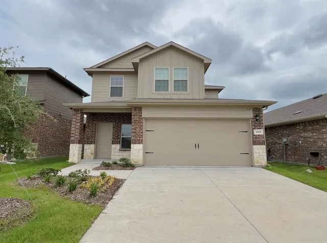 a view of a house with a yard and plants