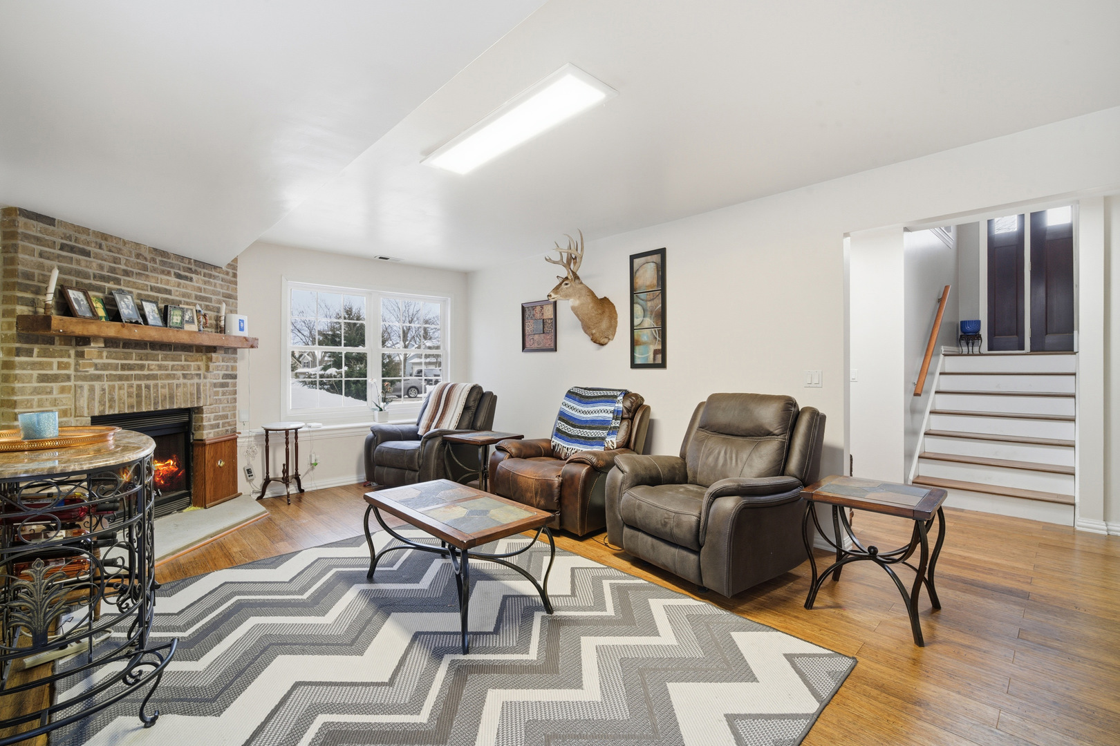 1032 Oak Tree Trail Lake Villa, IL 60046 - Photo 12 of 23 a living room with furniture a fireplace and wooden floor