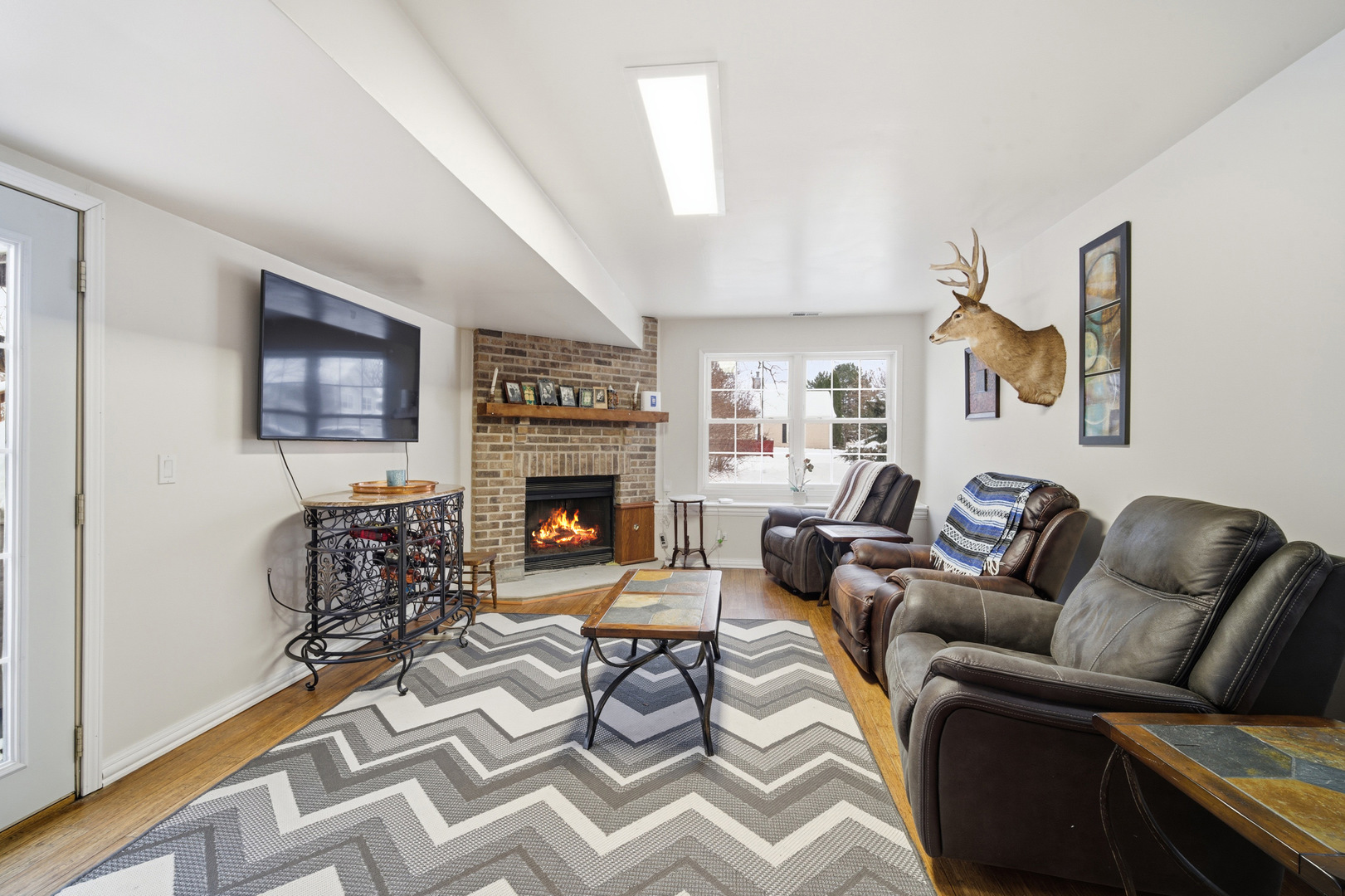 1032 Oak Tree Trail Lake Villa, IL 60046 - Photo 13 of 23 a living room with furniture fireplace and window