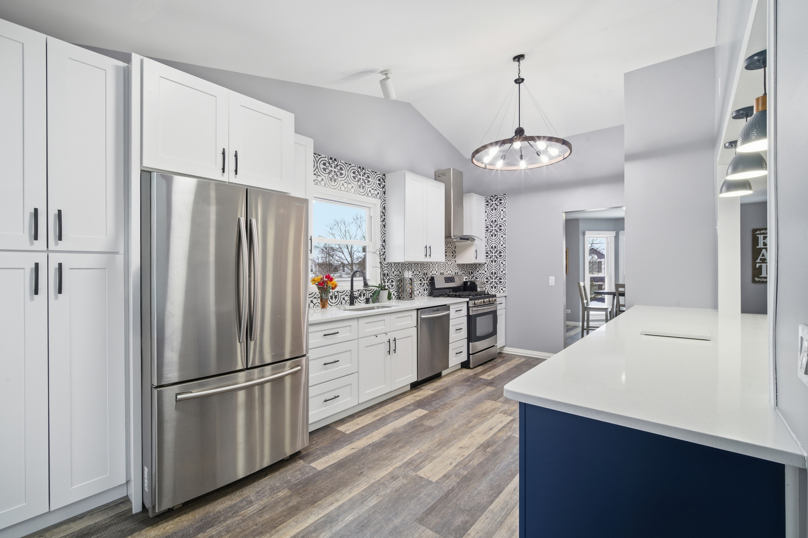 1032 Oak Tree Trail Lake Villa, IL 60046 - Photo 4 of 23 a kitchen with refrigerator a stove and white cabinets