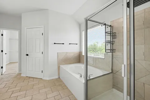 a bathroom with a bathtub and a shower
