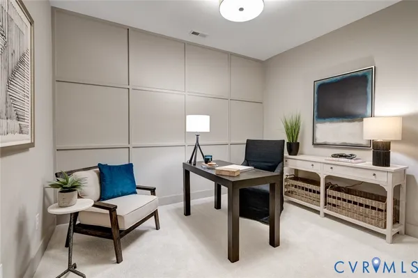 a reading room with furniture a flat screen tv and a workspace