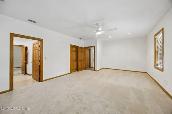 a view of an empty room with windows