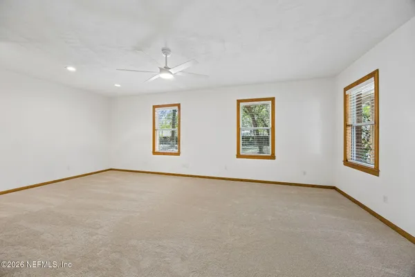 a view of walk in closet with empty racks