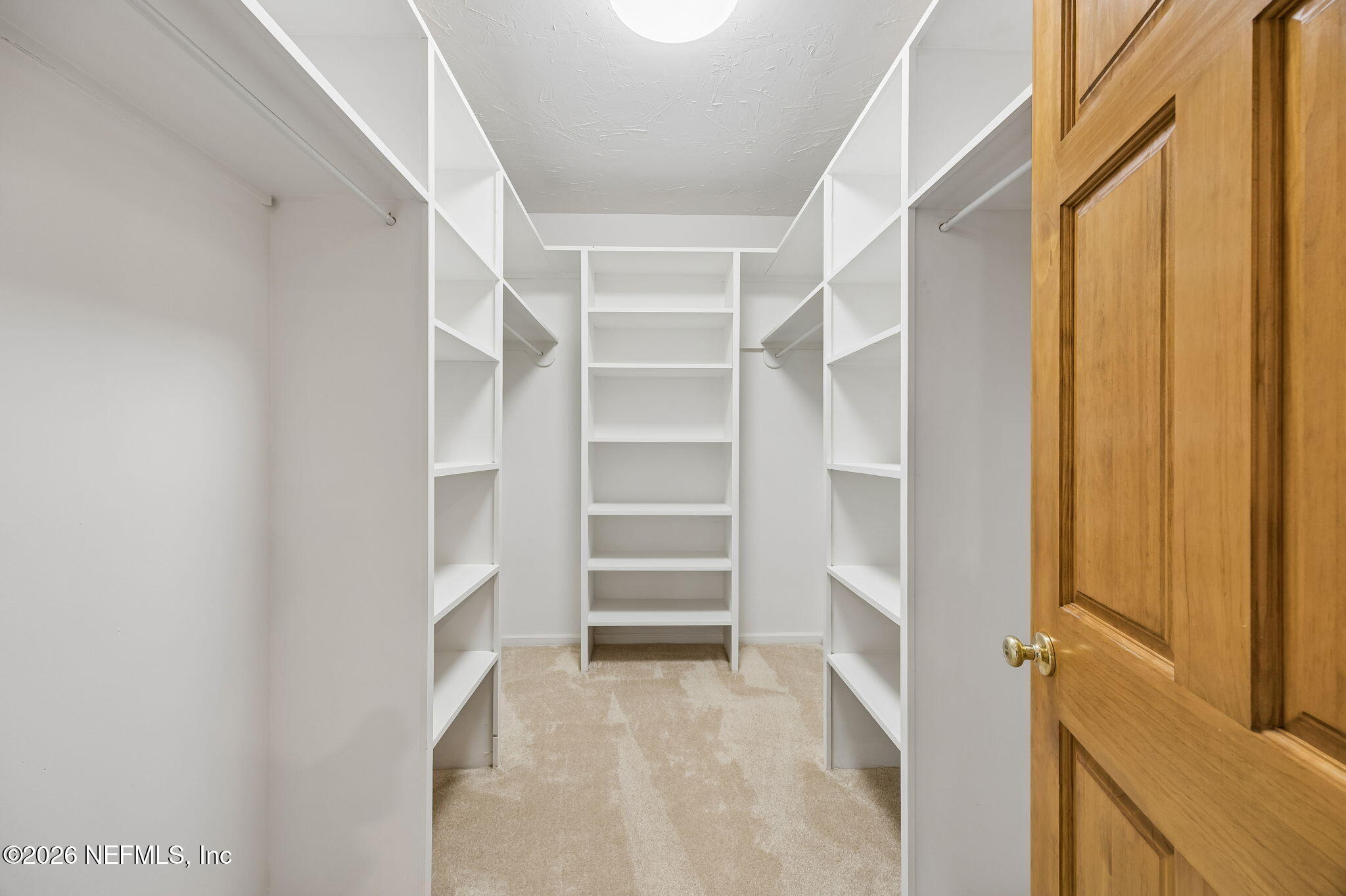 2538 Halperns Way Middleburg, FL 32068 - Photo 21 of 66 a view of walk in closet with empty racks