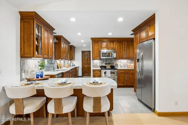 a kitchen with a sink cabinets and refrigerator