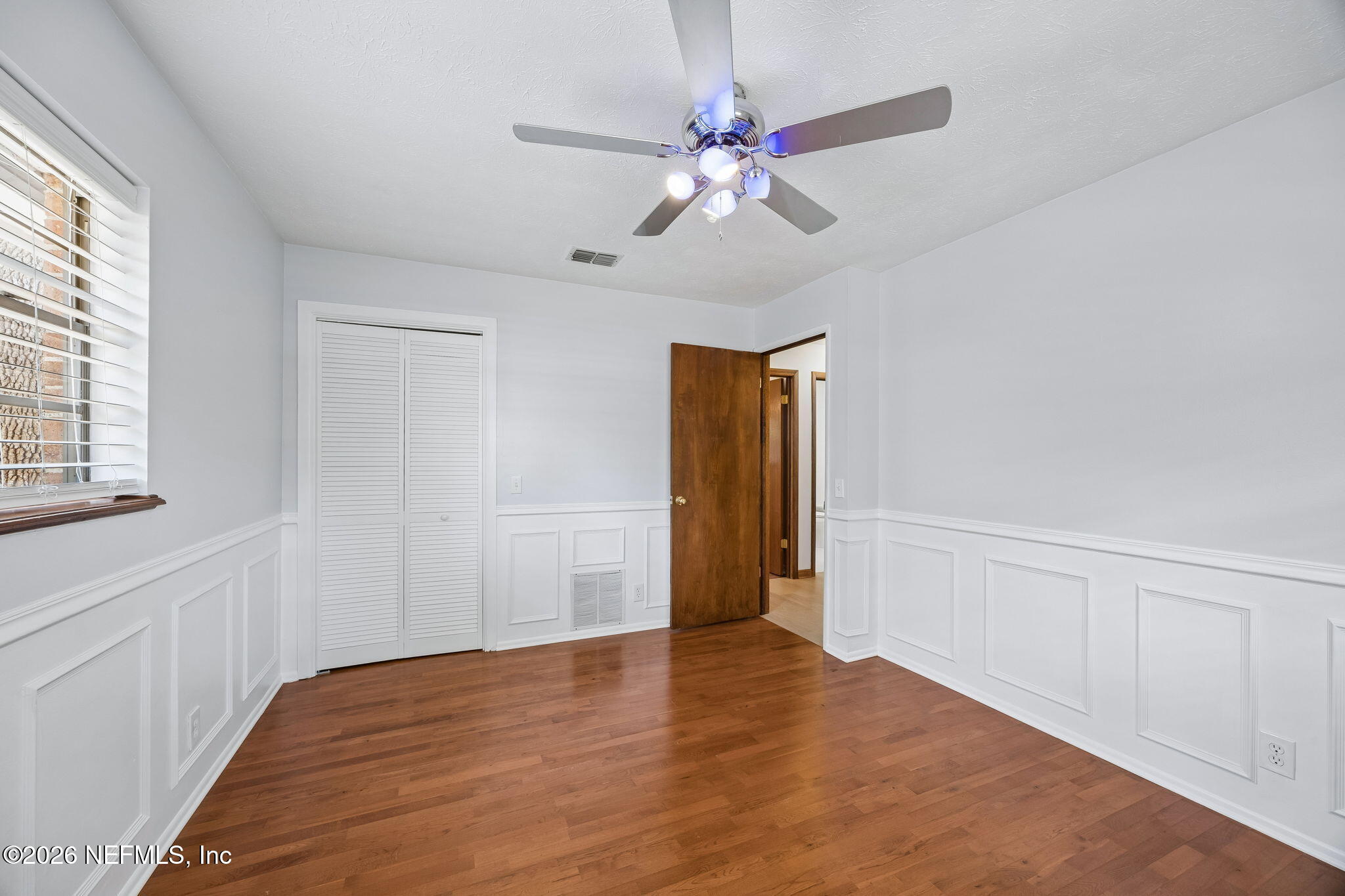 2538 Halperns Way Middleburg, FL 32068 - Photo 33 of 66 wooden floor in an empty room with a window