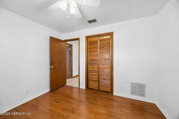 a view of empty room with wooden walls