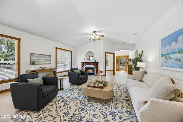 a living room with furniture ceiling fan and a rug