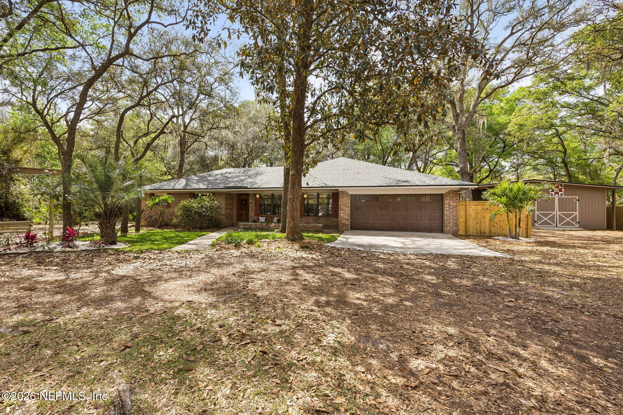 2538 Halperns Way Middleburg, FL 32068 - Photo 51 of 66 a front view of a house with a garden and trees