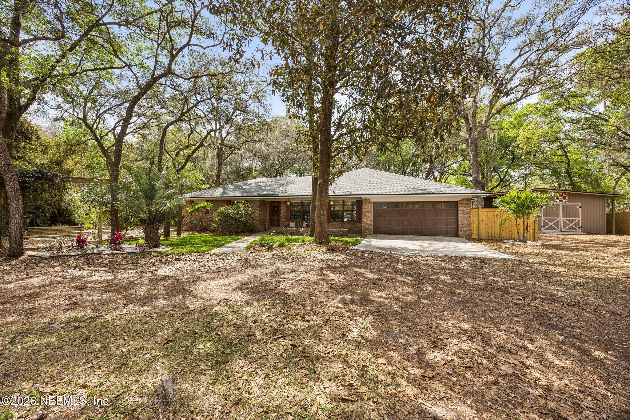 2538 Halperns Way Middleburg, FL 32068 - Photo 55 of 66 a front view of a house with a garden and trees