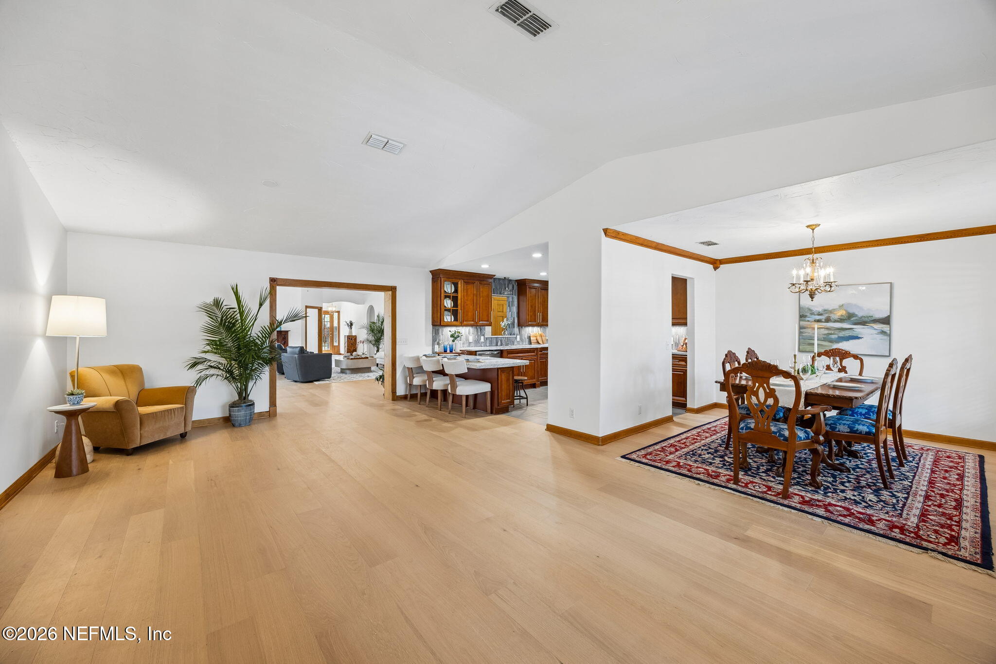 2538 Halperns Way Middleburg, FL 32068 - Photo 7 of 66 a living room with furniture and a dining table with wooden floor