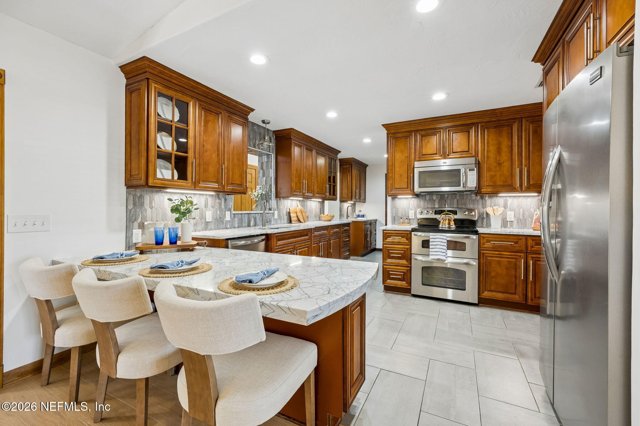 2538 Halperns Way Middleburg, FL 32068 - Photo 10 of 66 a kitchen with refrigerator a stove and chairs