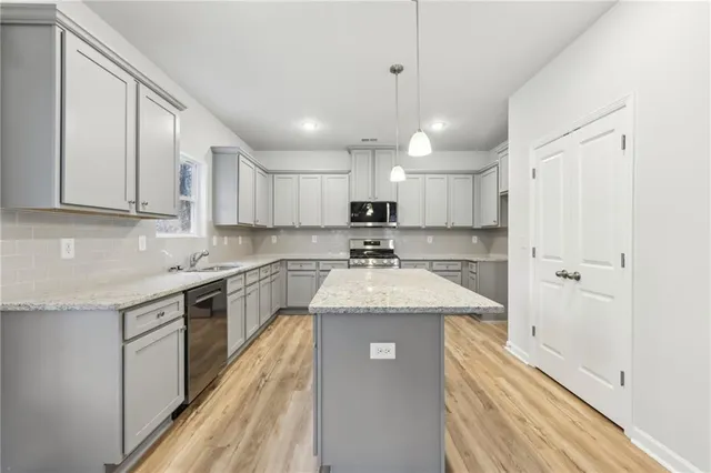 a kitchen with a sink window and cabinets