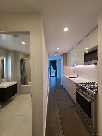 a kitchen with stainless steel appliances a stove a sink and a refrigerator