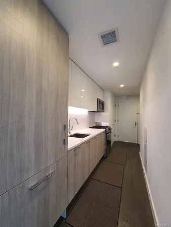 a large kitchen with stainless steel appliances a large counter top