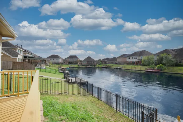 a view of a lake with houses in the back