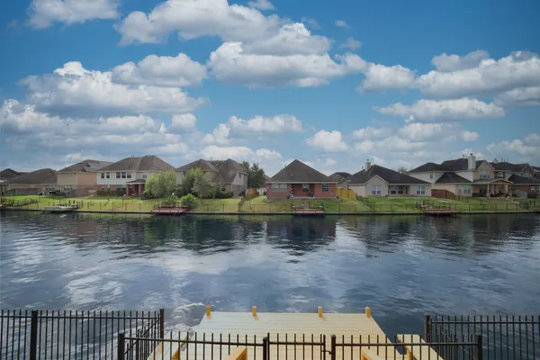 a view of a lake with houses in the back