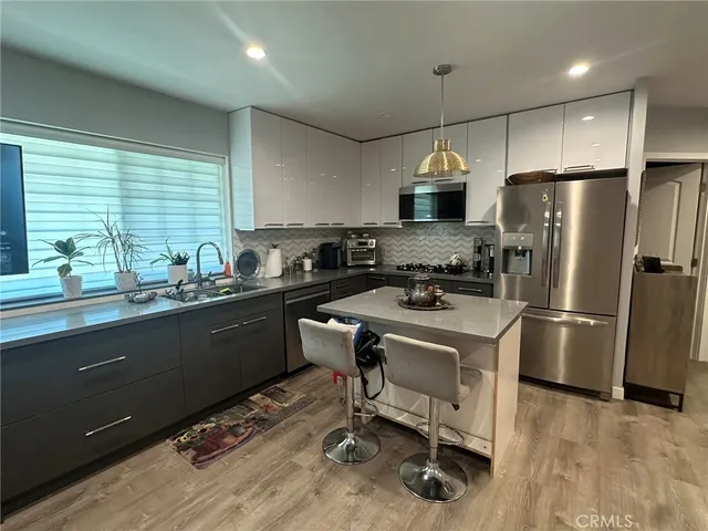 a kitchen with refrigerator cabinets and a table