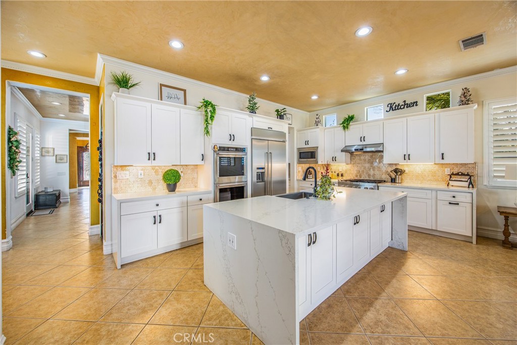 12794 Windstar Drive Rancho Cucamonga, CA 91739 - Photo 4 of 8 a large kitchen with kitchen island a sink a stove and a refrigerator