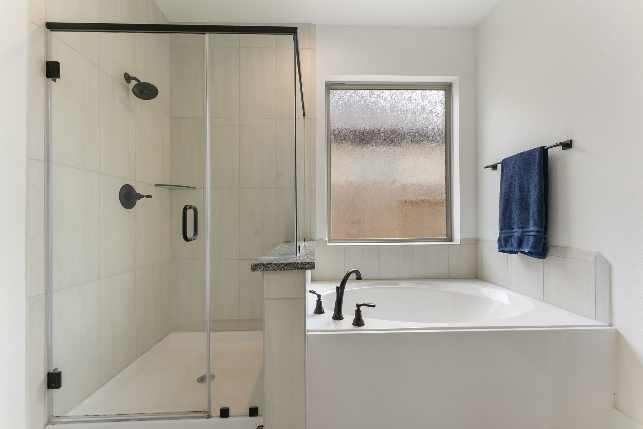 10659 Wild Chives Conroe, TX 77385 - Photo 10 of 23 Separate shower and soaking tub in the primary bathroom.