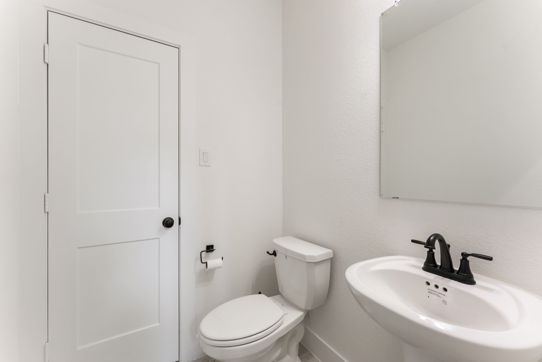10659 Wild Chives Conroe, TX 77385 - Photo 12 of 23 The powder room is conveniently located next to the home office.