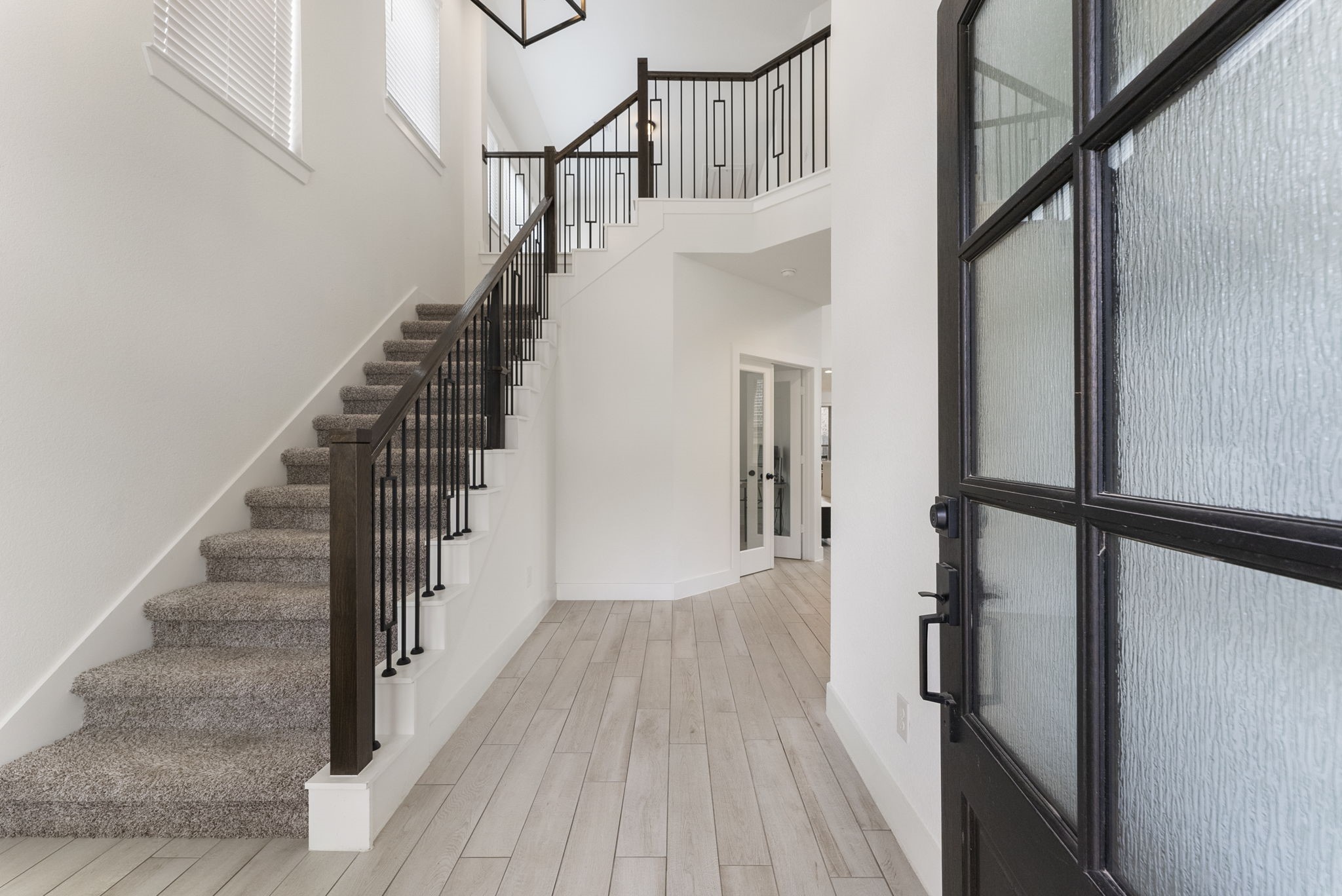 10659 Wild Chives Conroe, TX 77385 - Photo 3 of 23 Inside, durable tile flooring extends throughout the home’s high-traffic areas.