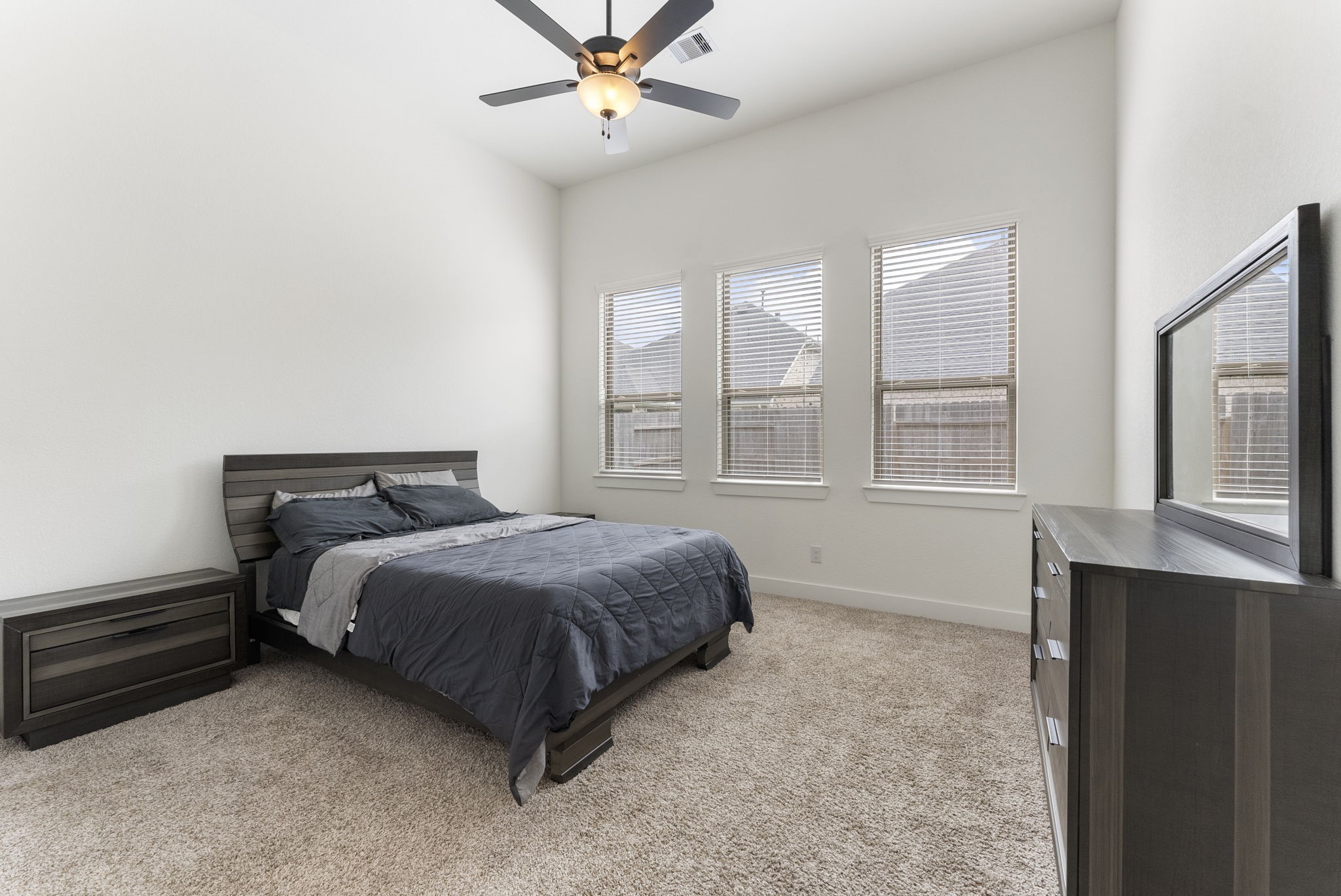 10659 Wild Chives Conroe, TX 77385 - Photo 8 of 23 The primary bedroom is tucked away at the back of the home, overlooking the backyard.