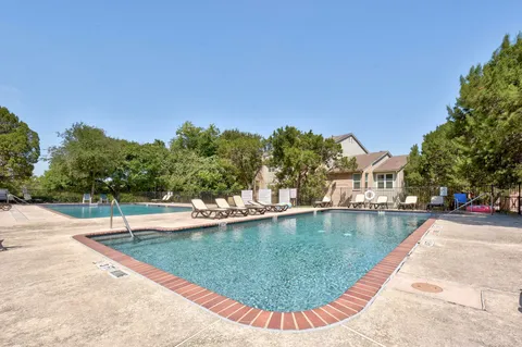 a view of a swimming pool with a lounge chairs