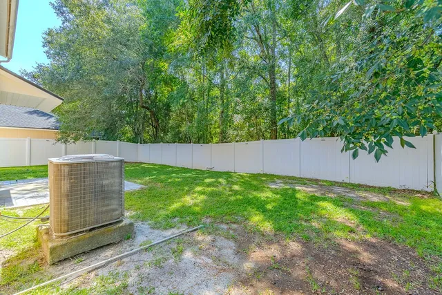 a kitchen with kitchen island granite countertop a sink a counter top space appliances and cabinets