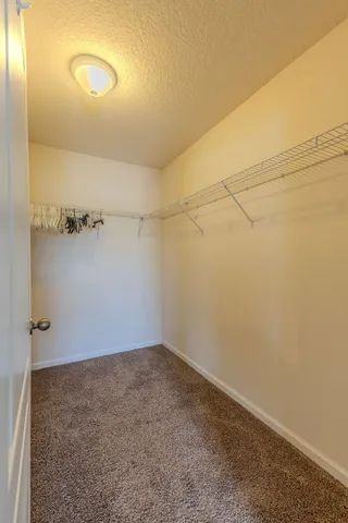 an empty room with fireplace and fan