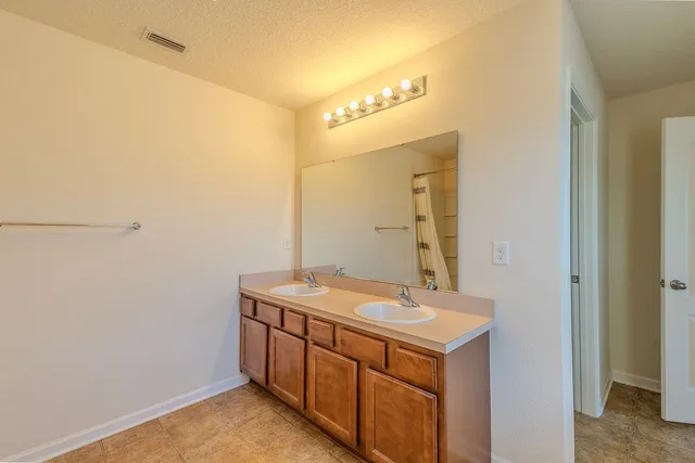 a bathroom with a toilet a sink and a mirror