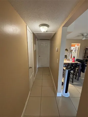 a hallway with dining area and chandelier