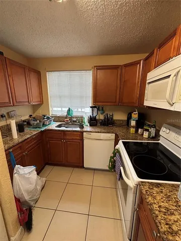 a kitchen with a sink a stove a microwave and cabinets