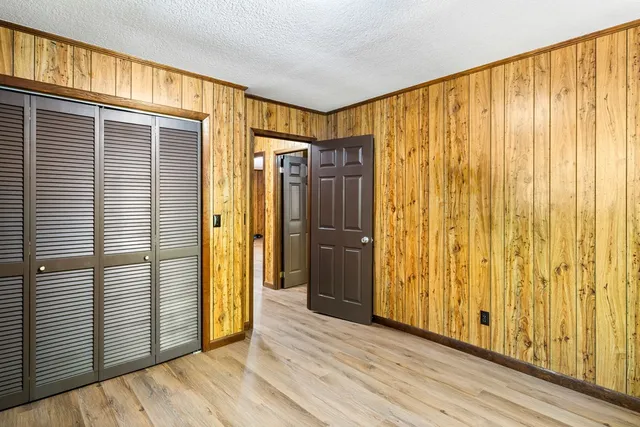 a view of a bathroom with shower and wooden floor
