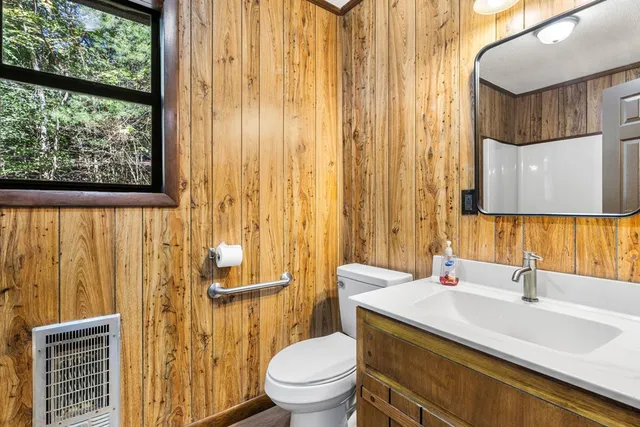 a bathroom with a sink a toilet and a mirror