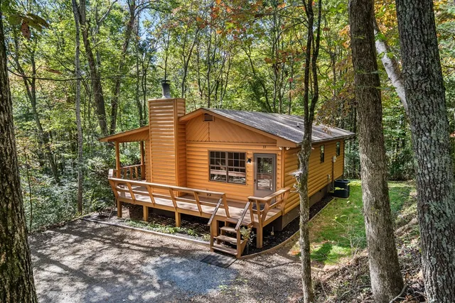 a front view of a house with a yard balcony and outdoor seating