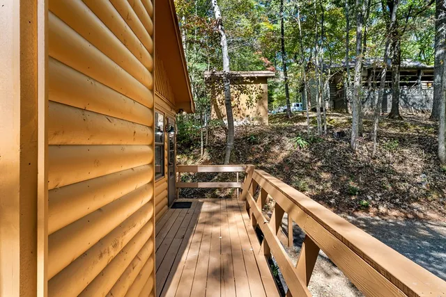 a view of balcony with wooden floor and fence