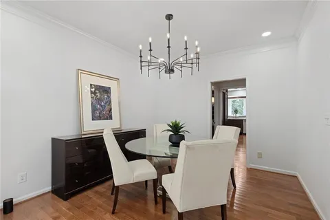 a view of a dining room with furniture and chandelier