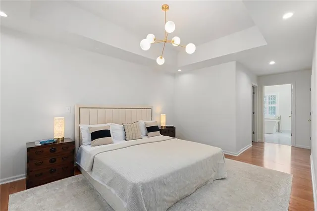 a bedroom with a bed and a chandelier