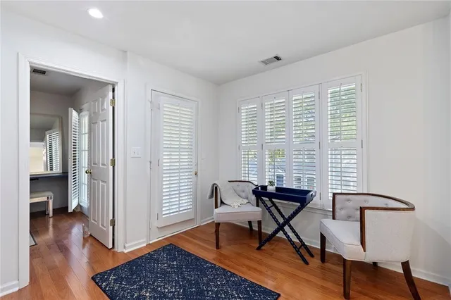 a view of a room with wooden floor and windows
