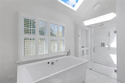 a bathroom with a bathtub and a shower