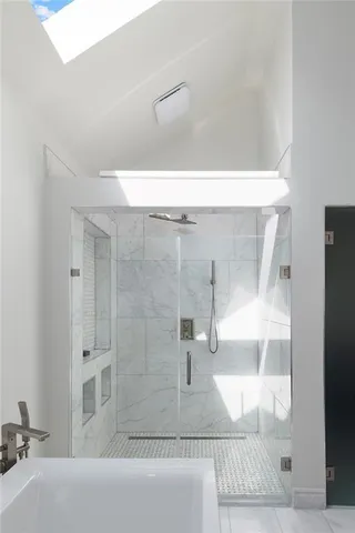 a bathroom with a bathtub and a shower