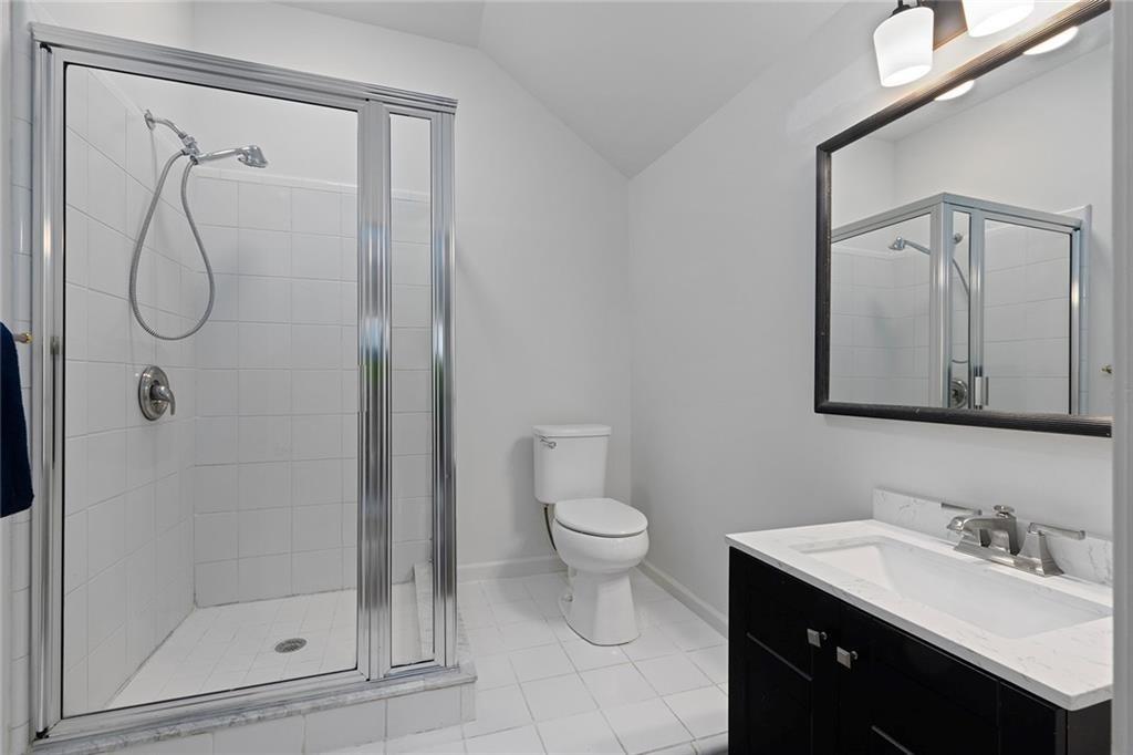 203 Ridley Lane Decatur, GA 30030 - Photo 31 of 43 a bathroom with a granite countertop sink a toilet and shower